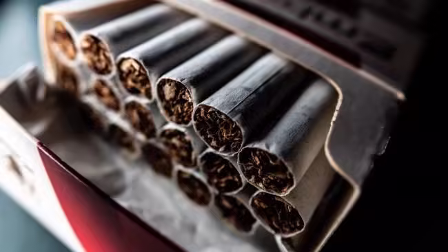Australia's tobacco tax revenue has halved in five years, with the illegal cigarette market exceeding $4 billion